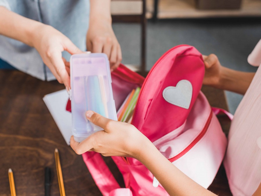 Mum and child packing school bag